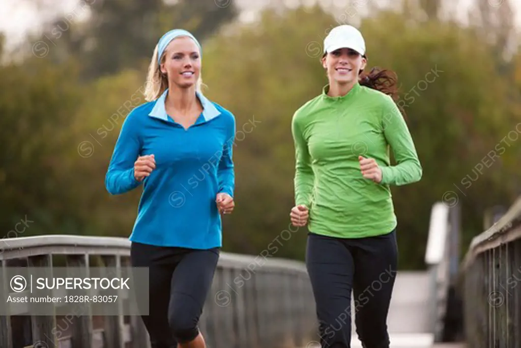 Two Women Jogging through Park