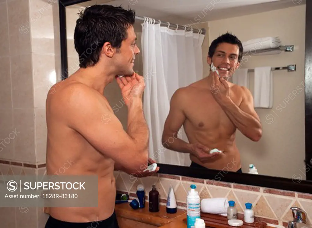 Man Shaving in Hotel Room, Reef Playacar Resort and Spa, Playa del Carmen, Mexico
