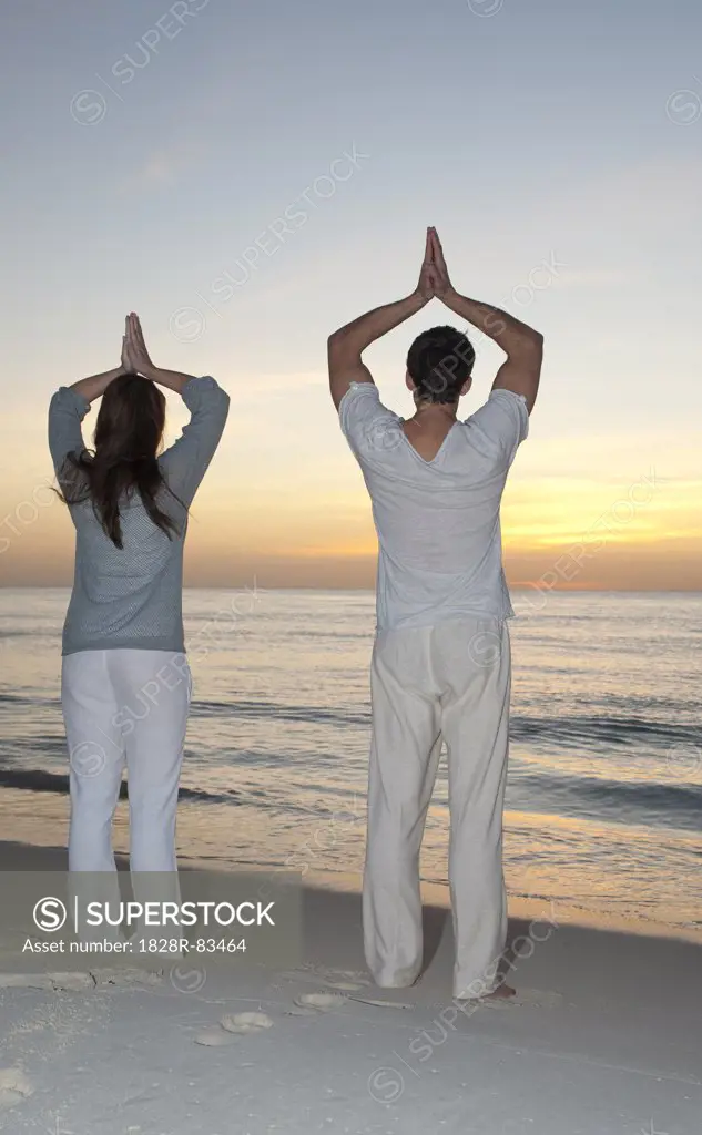 Couple doing Yoga on Beach, Reef Playacar Resort and Spa, Playa del Carmen, Mexico
