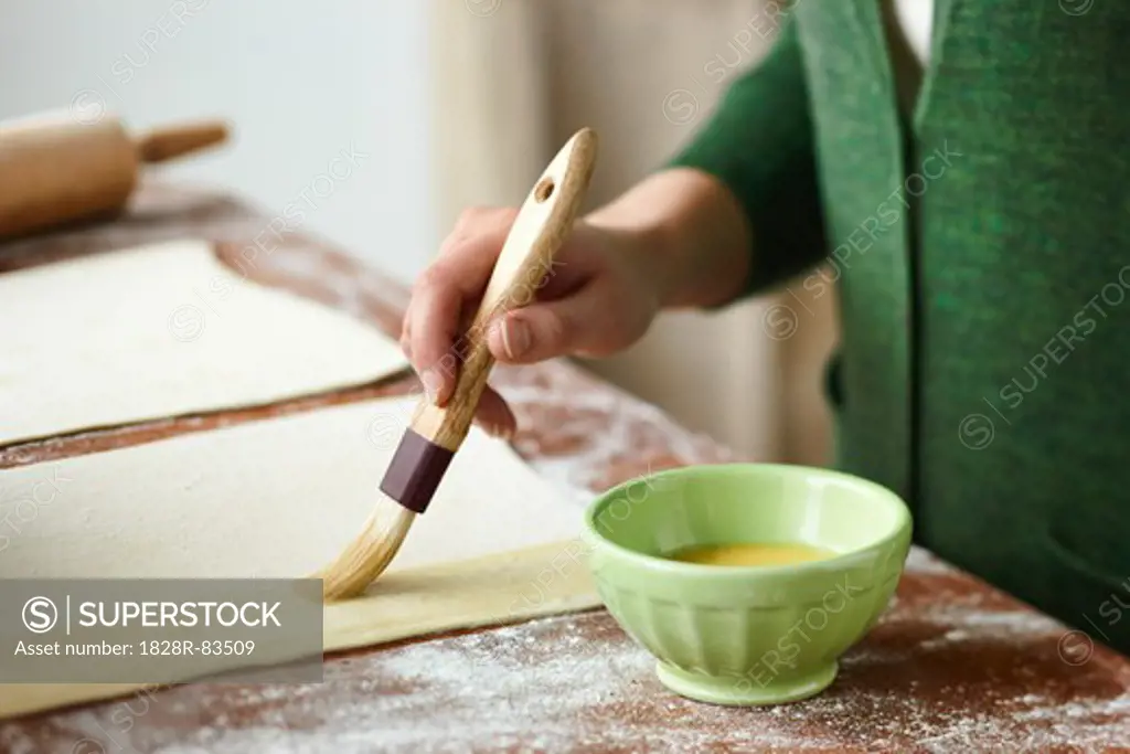 Woman Brushing Egg onto Pastry