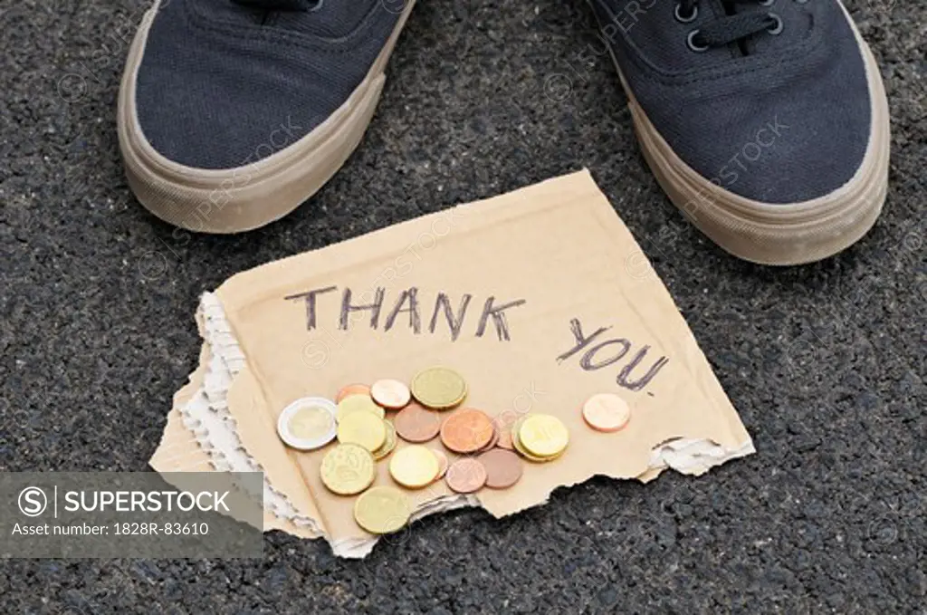 Feet with Spare Change and Thank You Sign