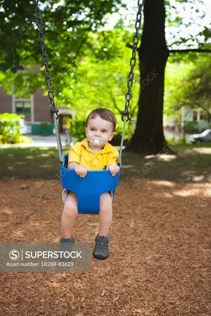 Boy Playing on Swings, Washington Park Playground, Portland, Oregon, USA