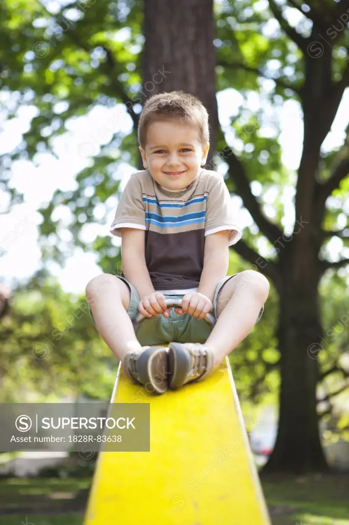 Boy Playing on Teeter-Totter, Washington Park Playground, Portland, Oregon, USA
