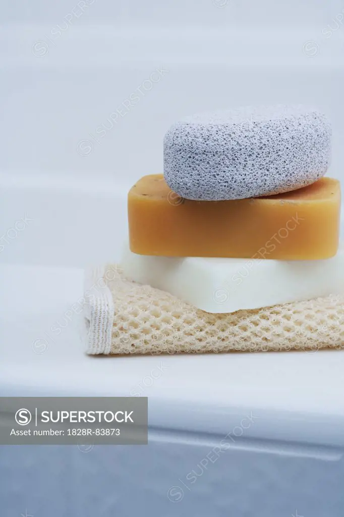 Soaps and Pumice Stone on edge of Tub