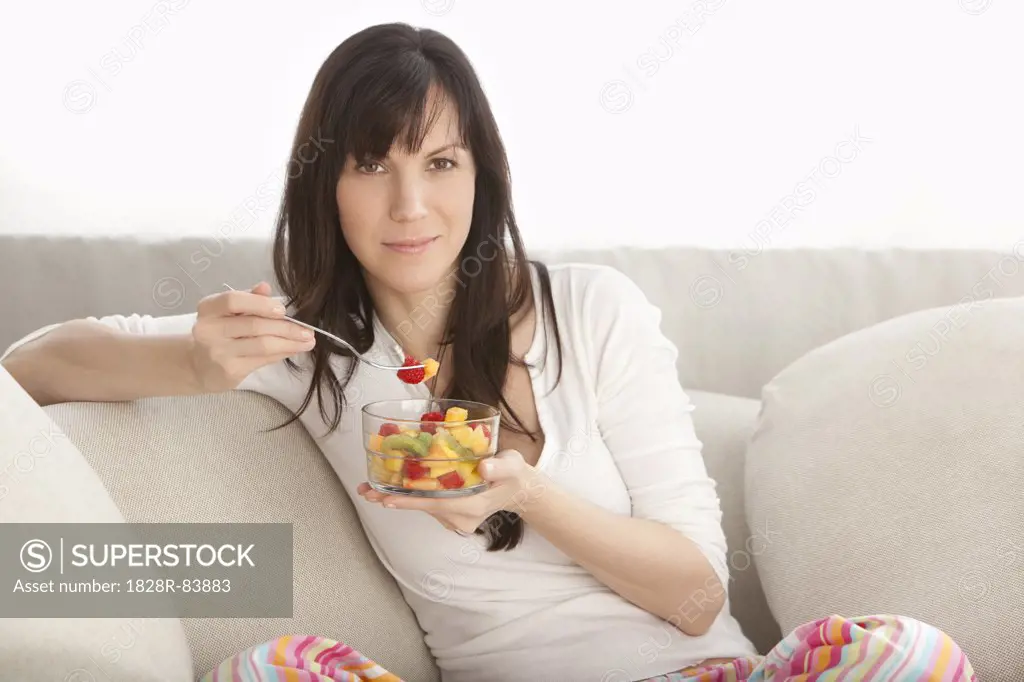 Portrait of Woman Eating Fruit Salad