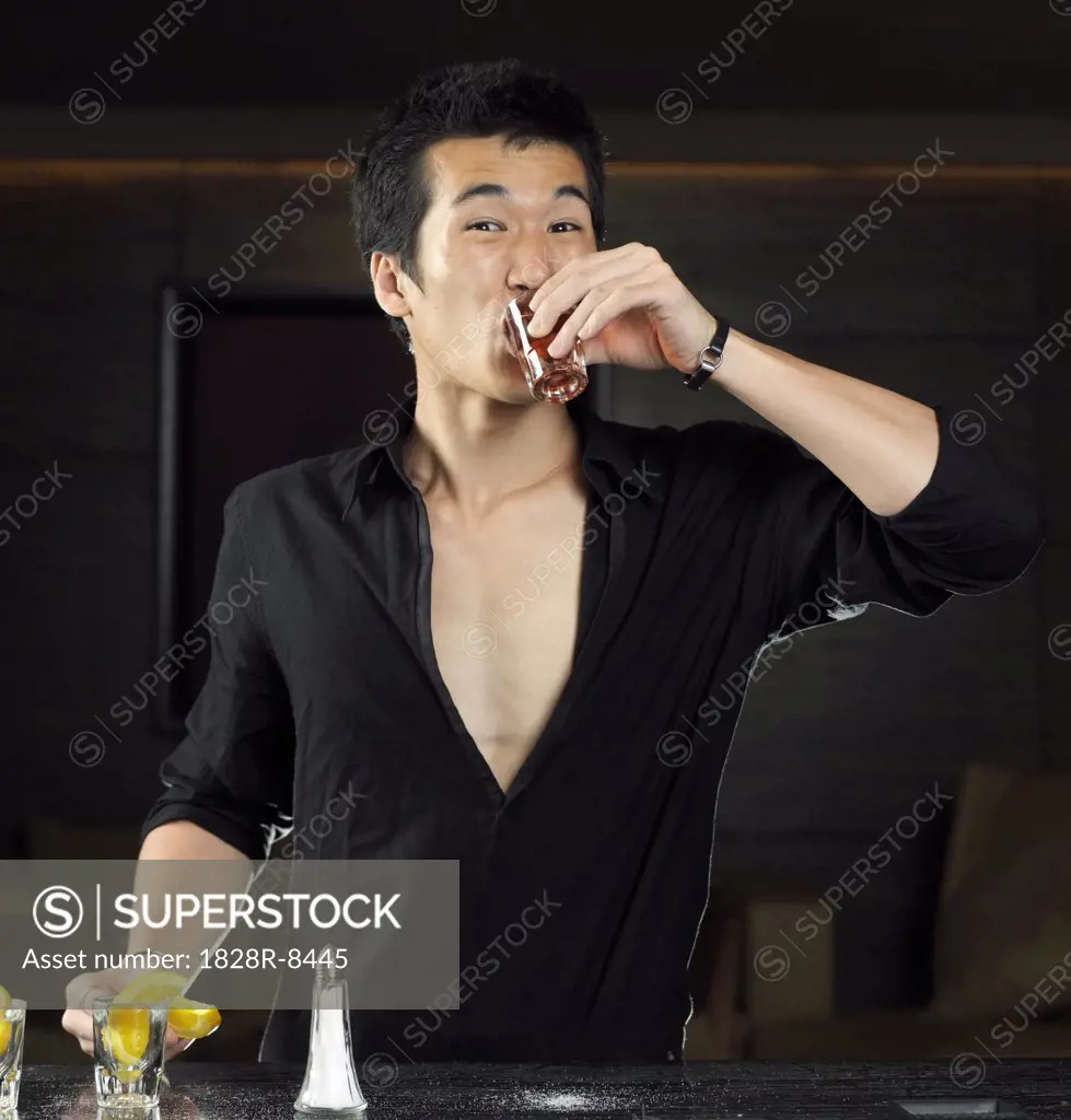 Man Drinking Shot at Bar   