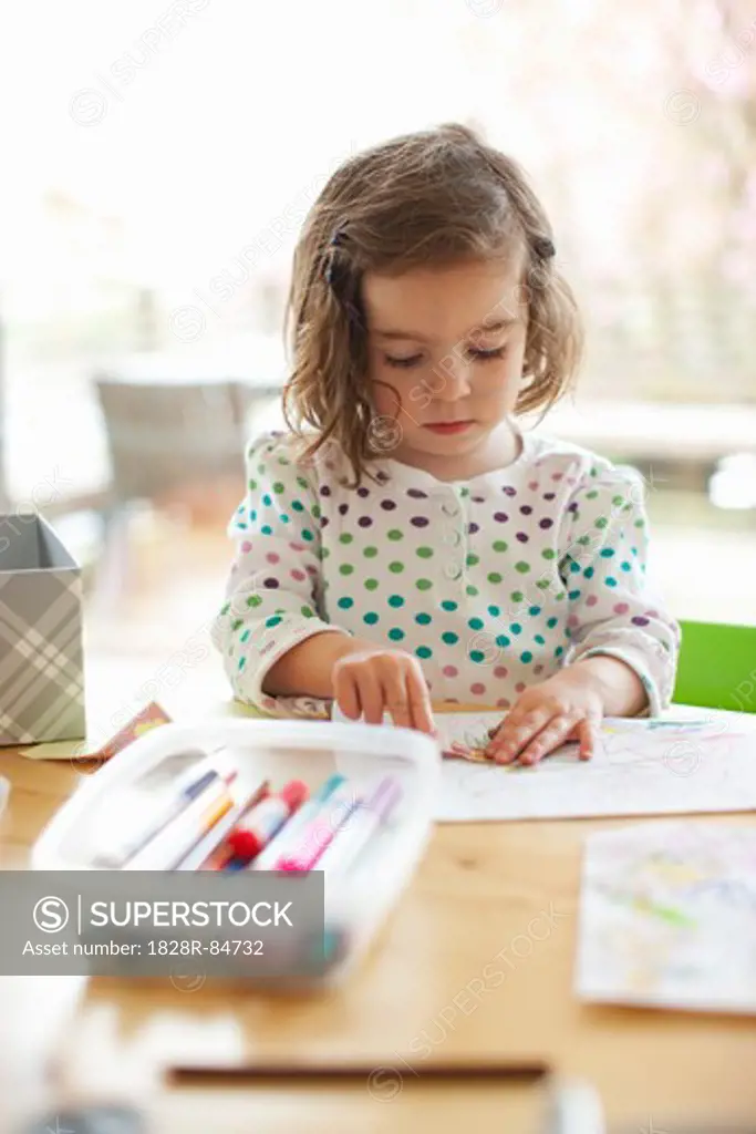 Girl Colouring at Kitchen Table
