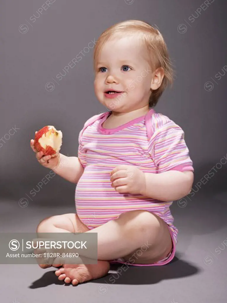 Baby Girl Eating an Apple