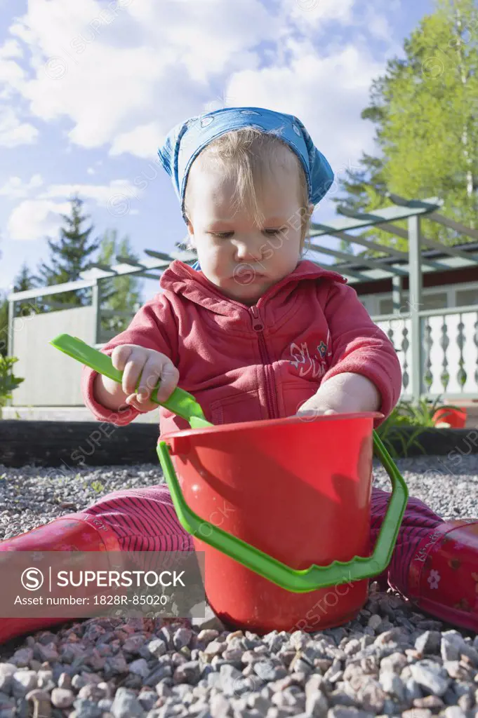 Girl Playing with Shovel and Pail