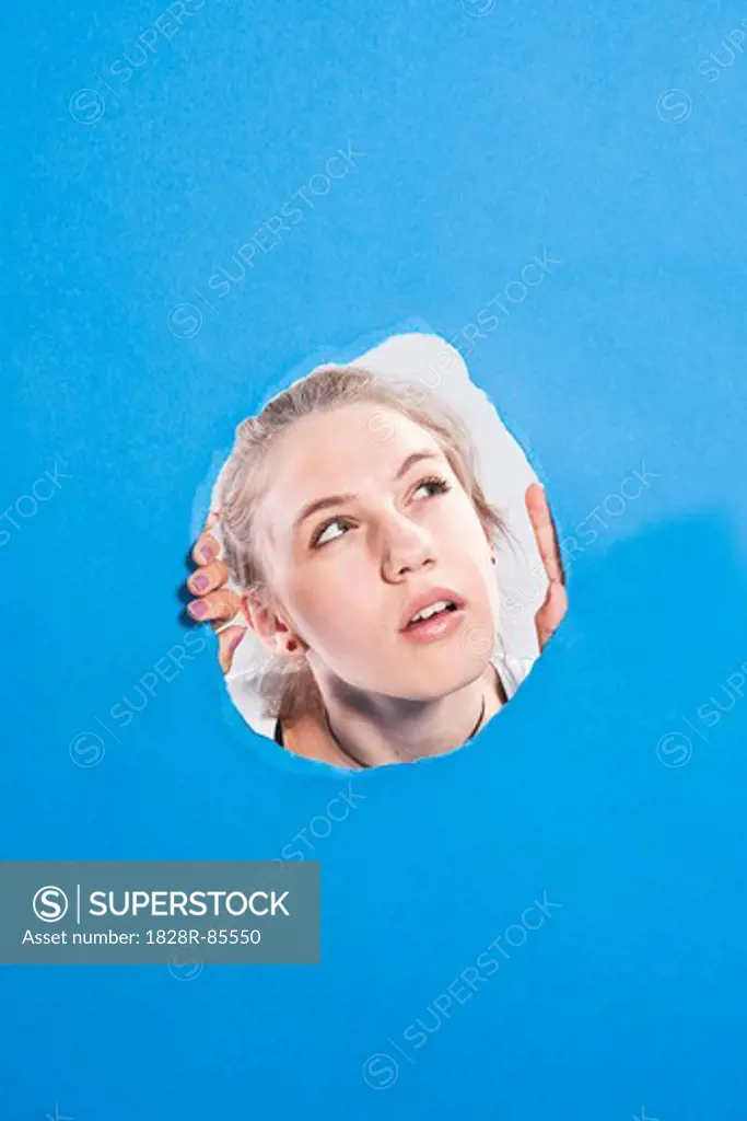 Teenage Girl Looking Through Hole