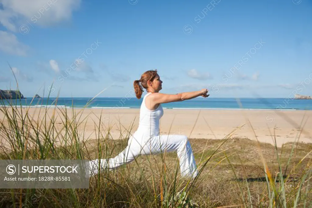 Woman Practicing Yoga on Beach, Camaret-sur-Mer, Finistere, Bretagne, France