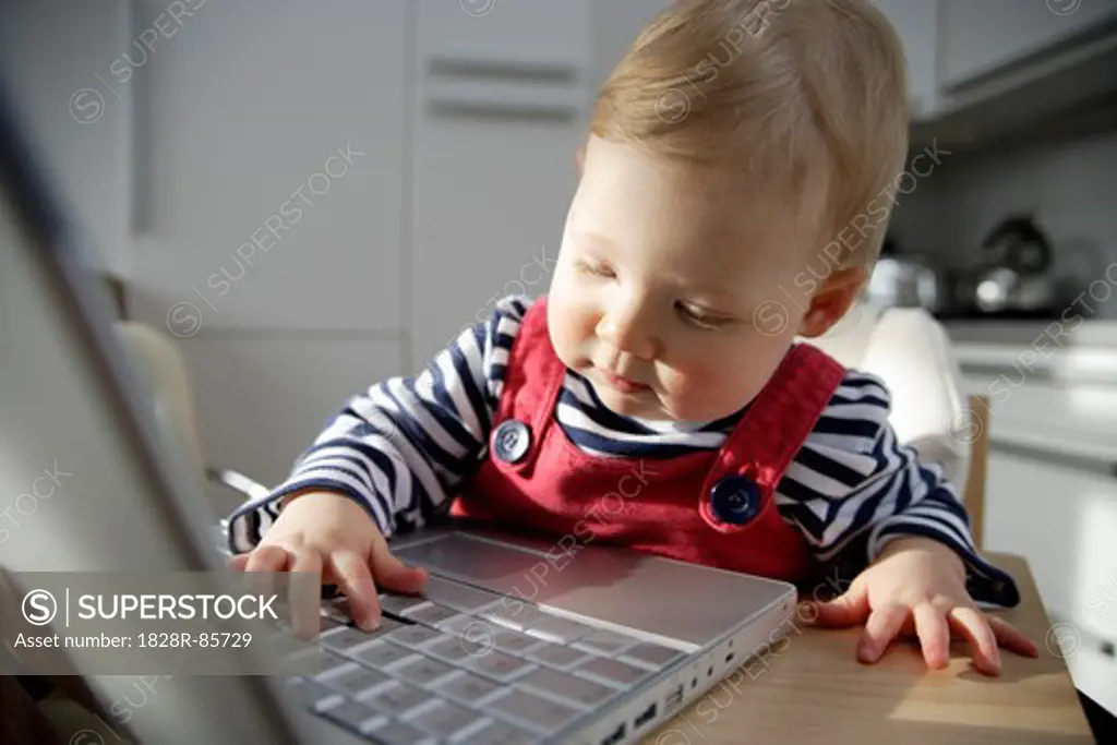 Baby Girl Playing with Laptop, London, England