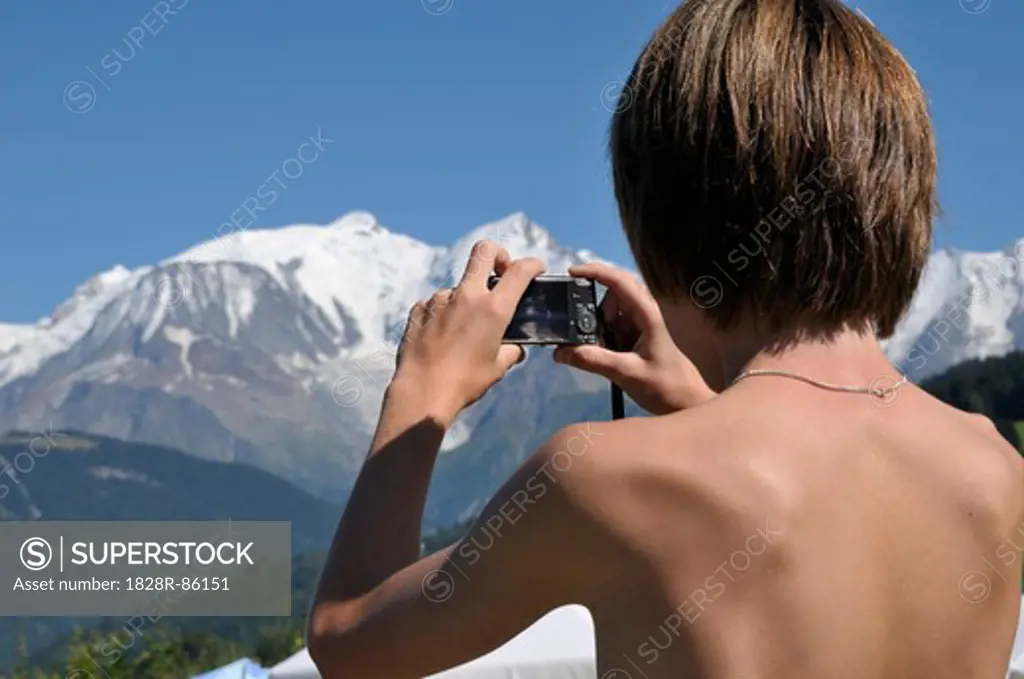 Back View of Boy taking Picture of Mountains, Alps, France