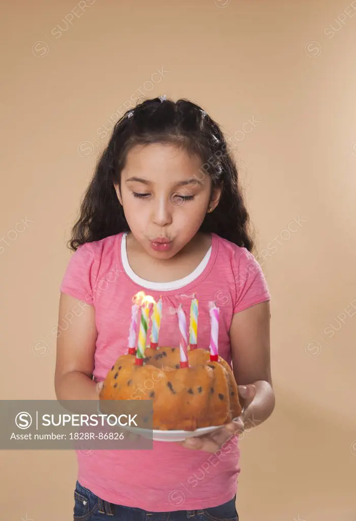 Portrait of Girl Blowing Out Candles