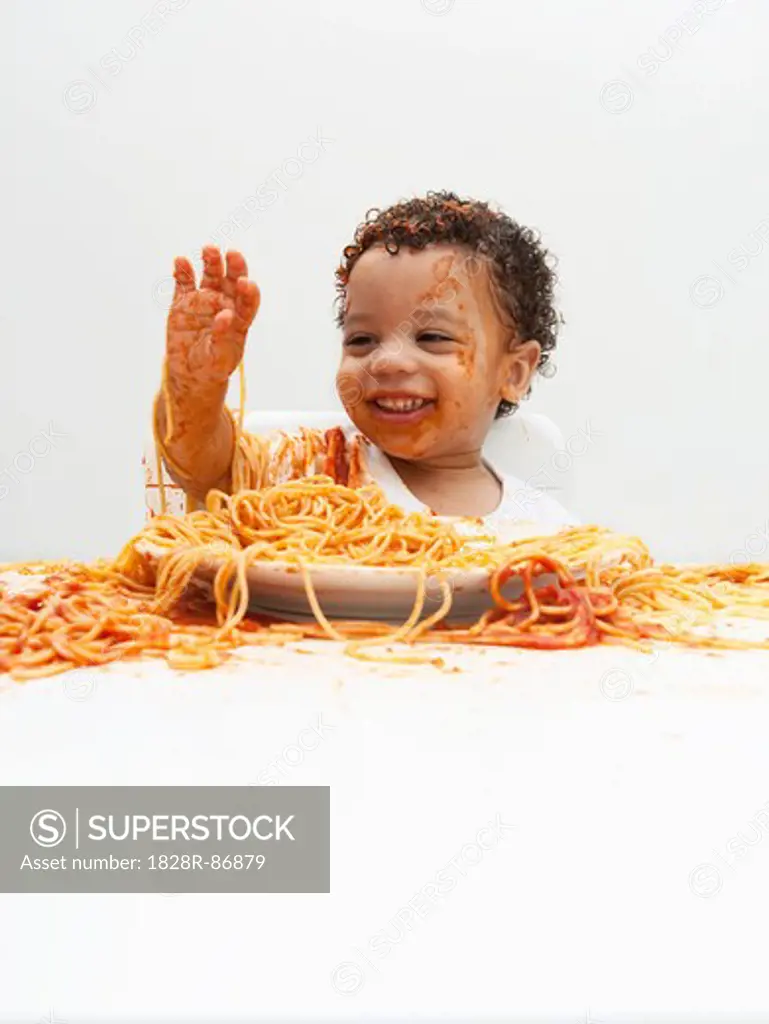 Boy eating Spaghetti with Hands
