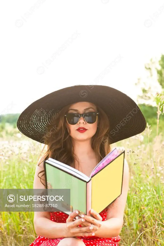 Woman Reading Book in Field