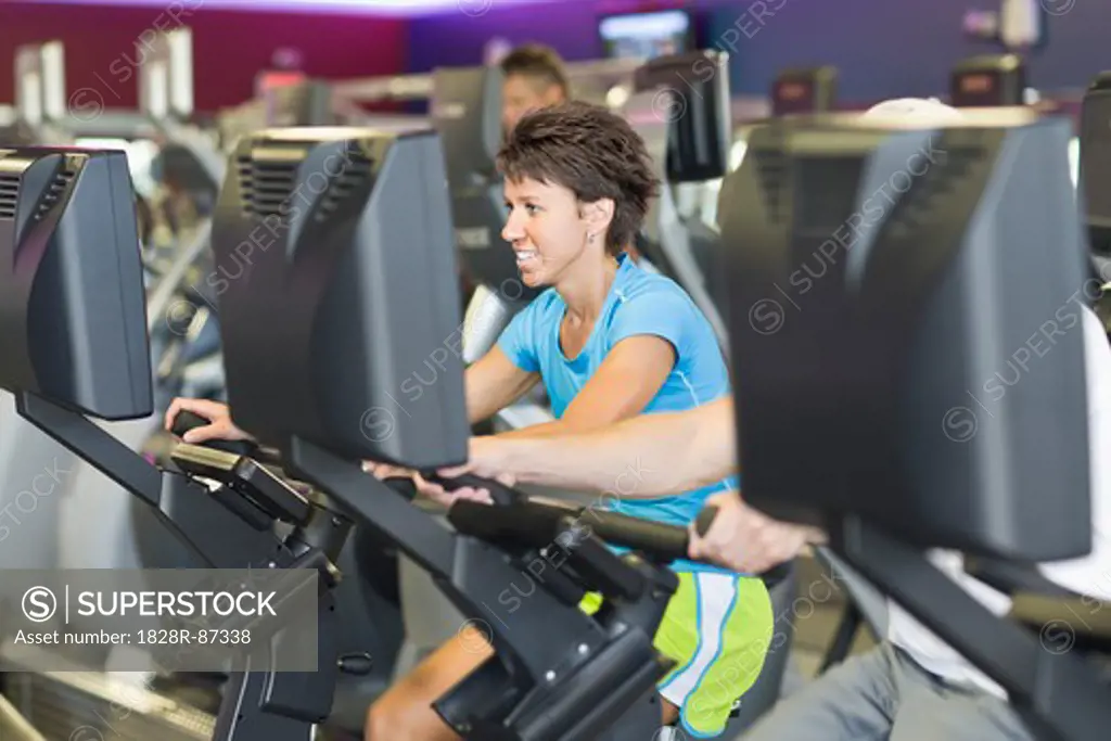 Woman using Exercise Equipment in Gym