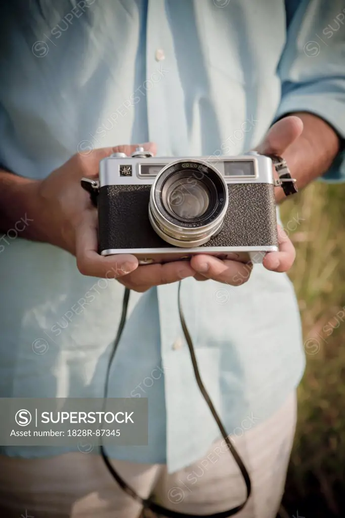 Close-up of Man holding Vintage Camera