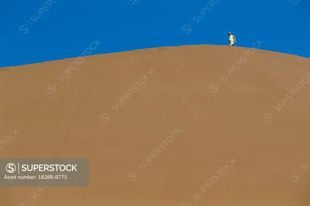 Person Walking on Sand Dune, Namib Desert, Namibia, Africa   