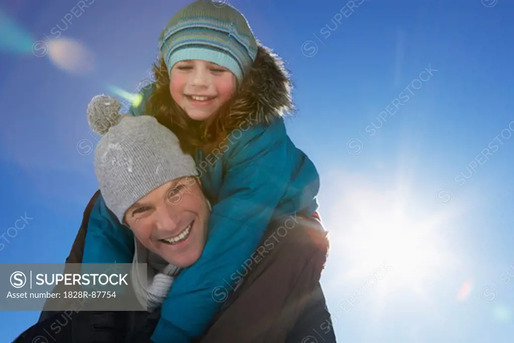 Father Giving Daughter Piggyback Ride