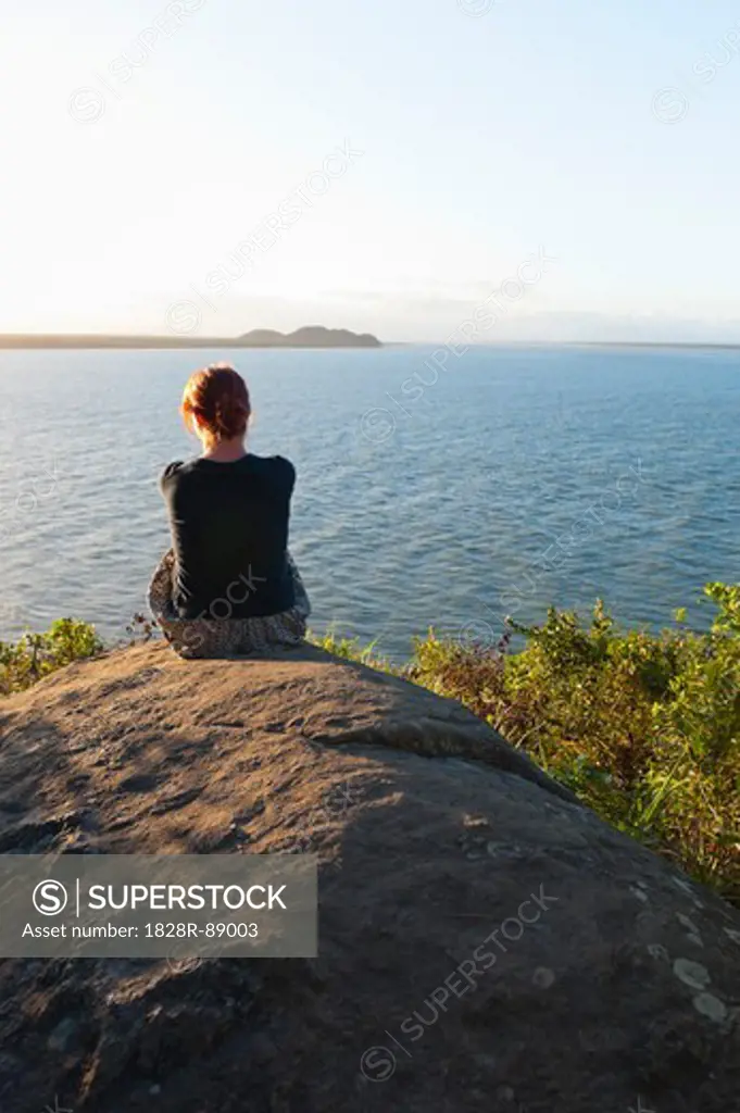 Backview of Woman Sitting on Rock, Ilha do Mel, Parana, Brazil