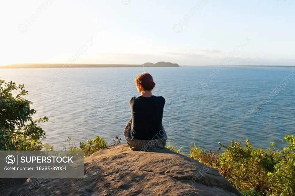 Backview of Woman Sitting on Hill, Ilha do Mel, Parana, Brazil