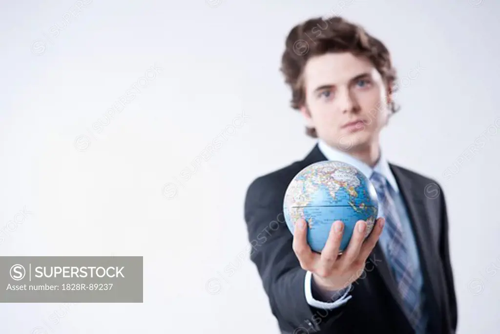 Portrait of Young Businessman holding World Globe