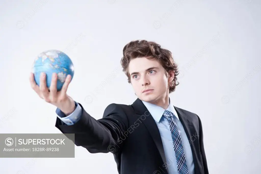 Portrait of Young Businessman holding World Globe