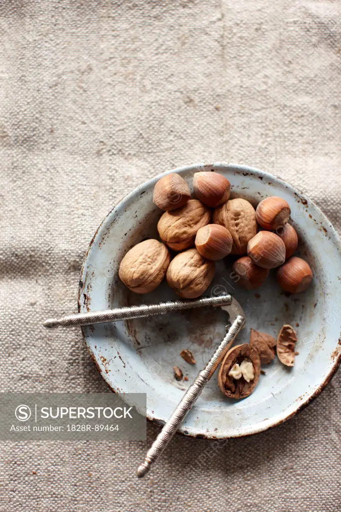 Walnuts and Hazelnuts in Bowl with Nutcracker