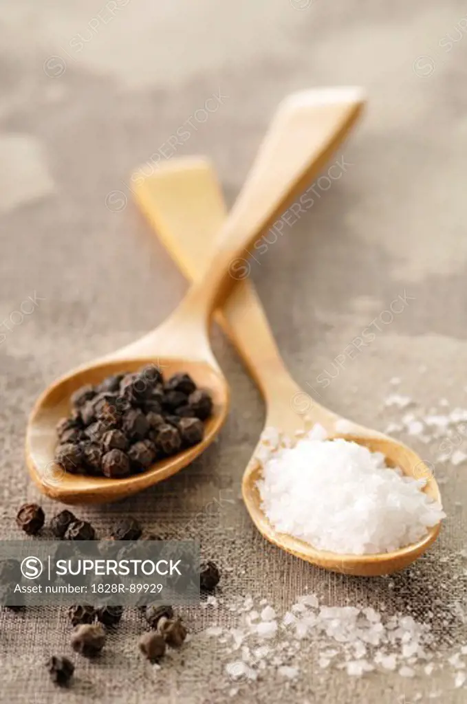 Rock Salt and Peppercorns in Wooden Spoons