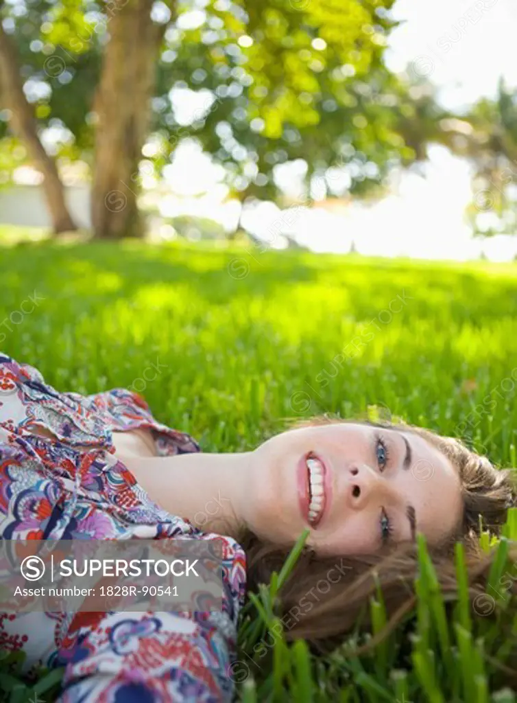 Woman Lying on Grass, Miami Beach, Florida, USA