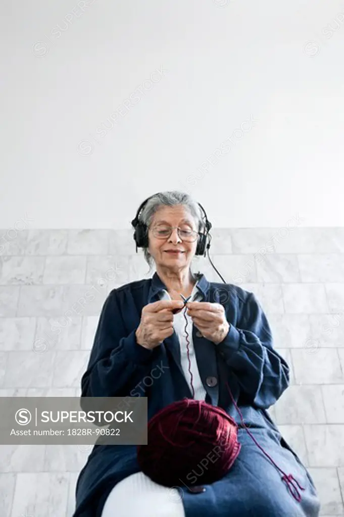 Woman Knitting and Listening to Headphones