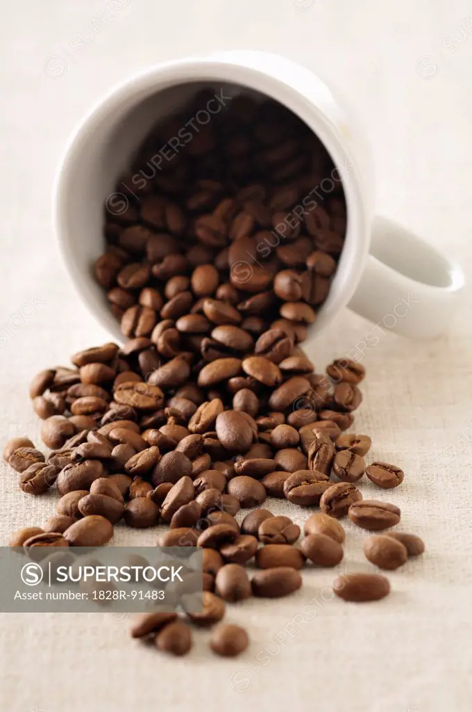 Close-up of Coffee Beans Spilling out of Mug