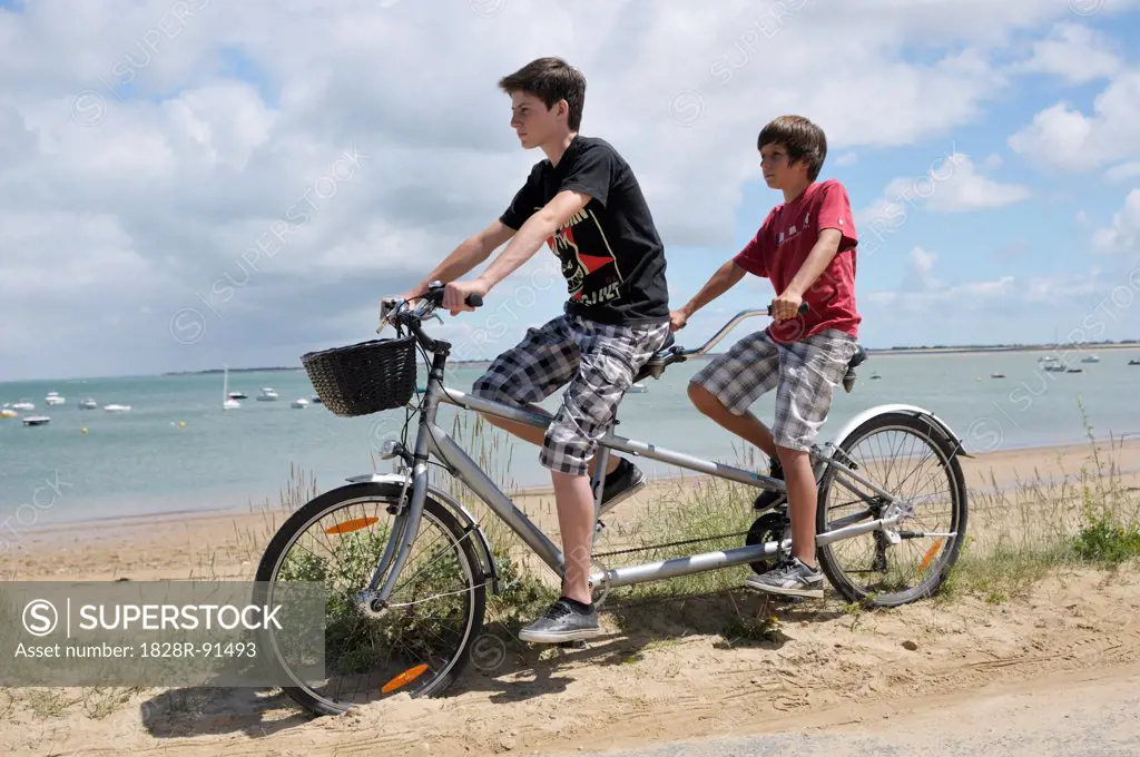 Brothers Riding Tandem Bicycle on Beach, Ile de Re, France