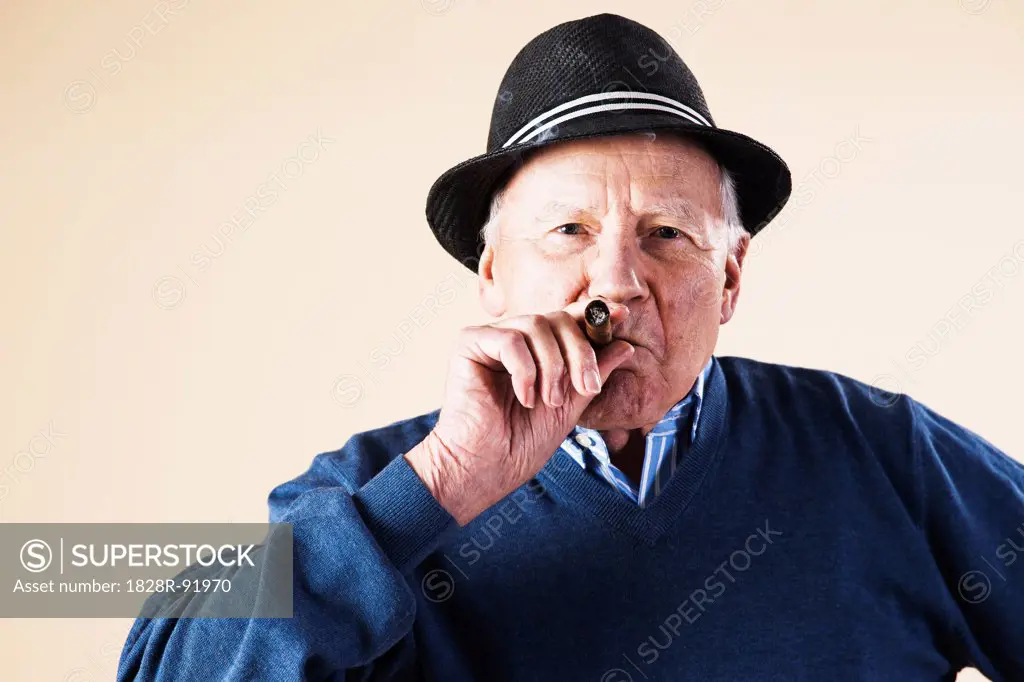 Portrait of Senior Man Smoking Cigar