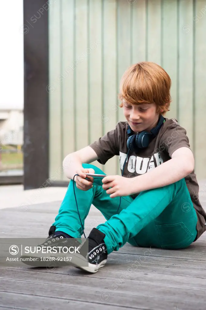 Boy with MP3 Player Outdoors, Mannheim, Baden-Wurttemberg, Germany