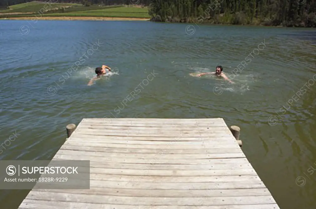 Men Swimming by Dock   