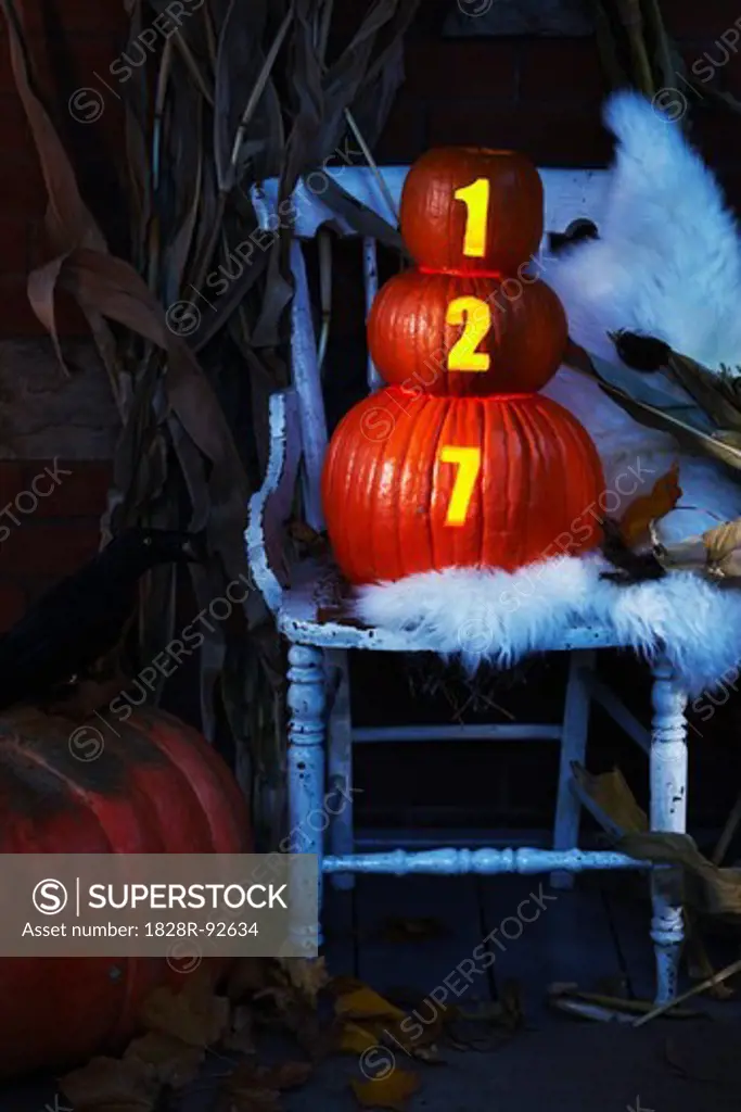 Front Porch Decorated for Halloween with Chair and Pumpkins with House Number Illuminated, Toronto, Ontario, Canada