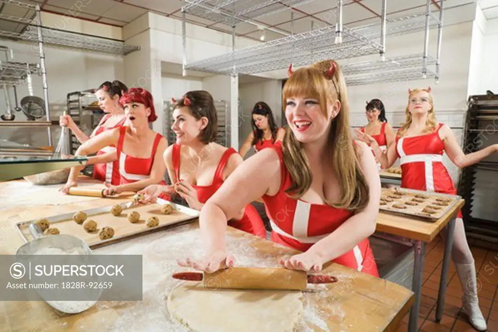 Women Wearing Devil Horns Working at a Bakery, Oakland, Alameda County, California, USA