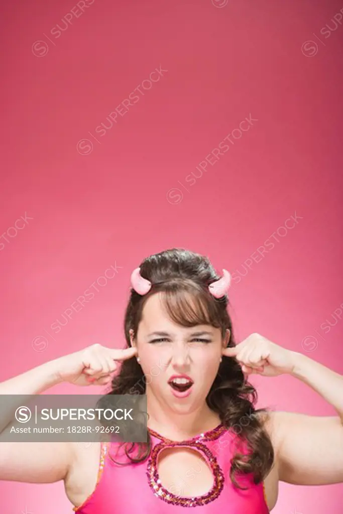 Portrait of Woman Wearing Devil Horns and Plugging Ears