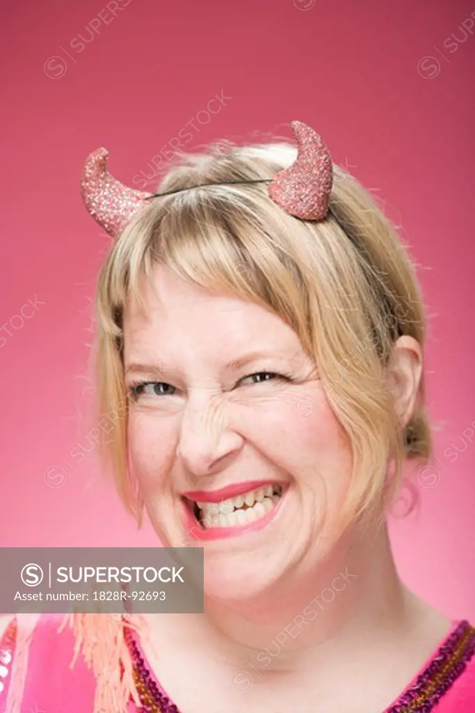 Portrait of Woman Wearing Devil Horns and Scowling