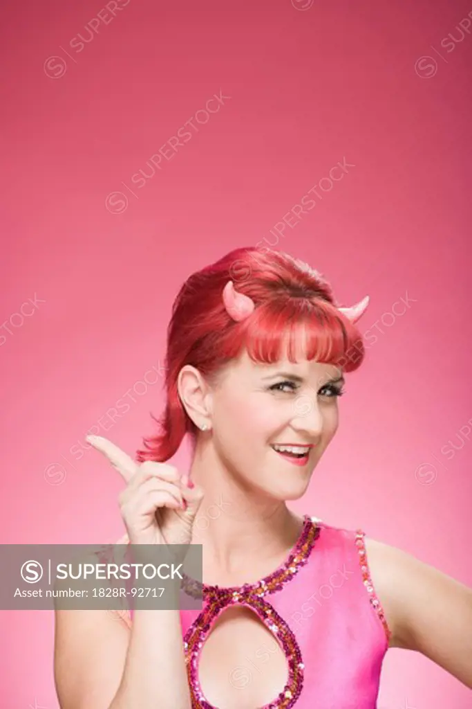 Portrait of Woman Wearing Devil Horns Wagging Finger