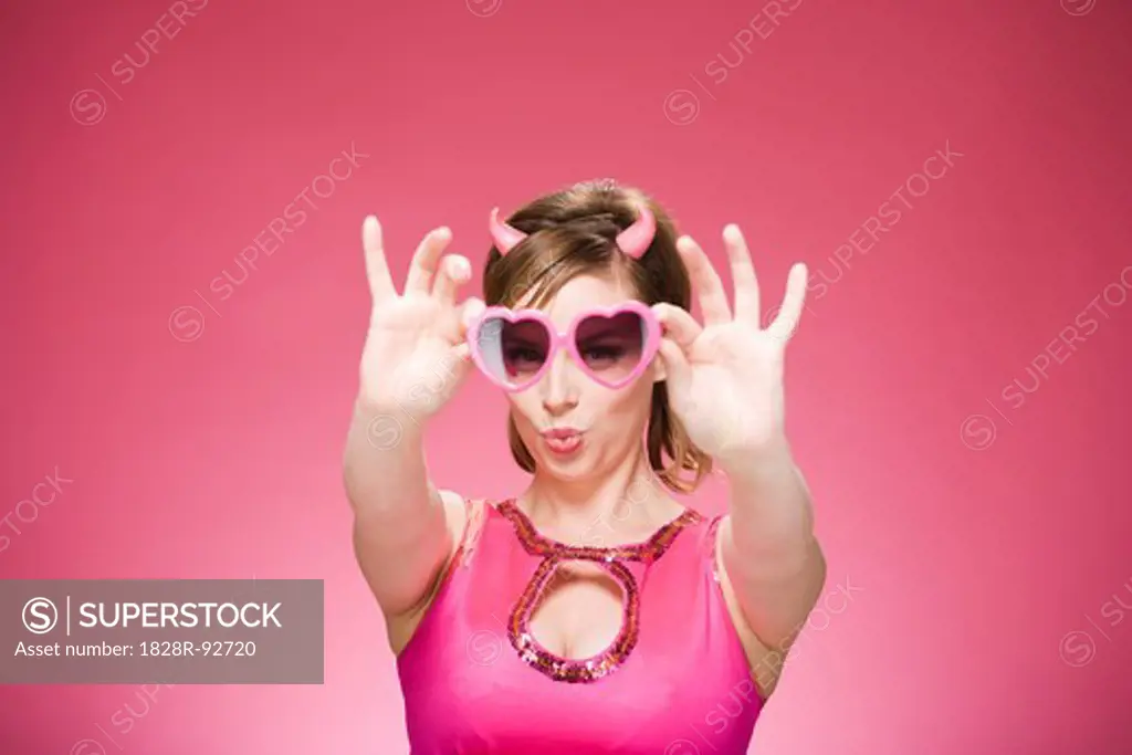 Portrait of Woman Wearing Devil Horns and Heart Shaped Eyeglasses