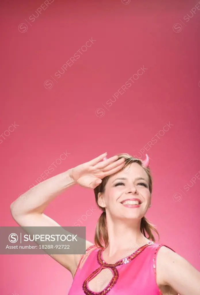 Portrait of Woman Wearing Devil Horns and Saluting