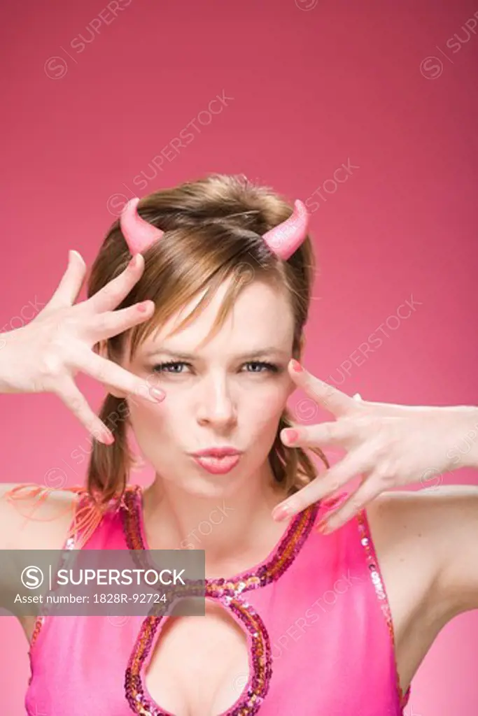 Portrait of Woman Wearing Devil Horns Making Faces