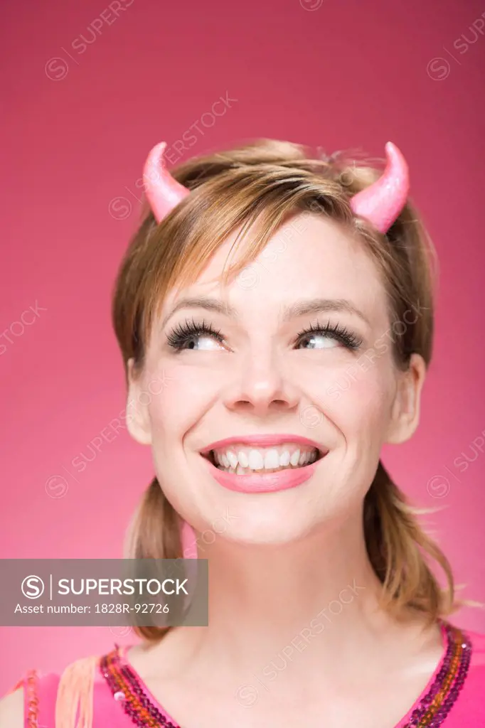 Portrait of Woman Wearing Devil Horns