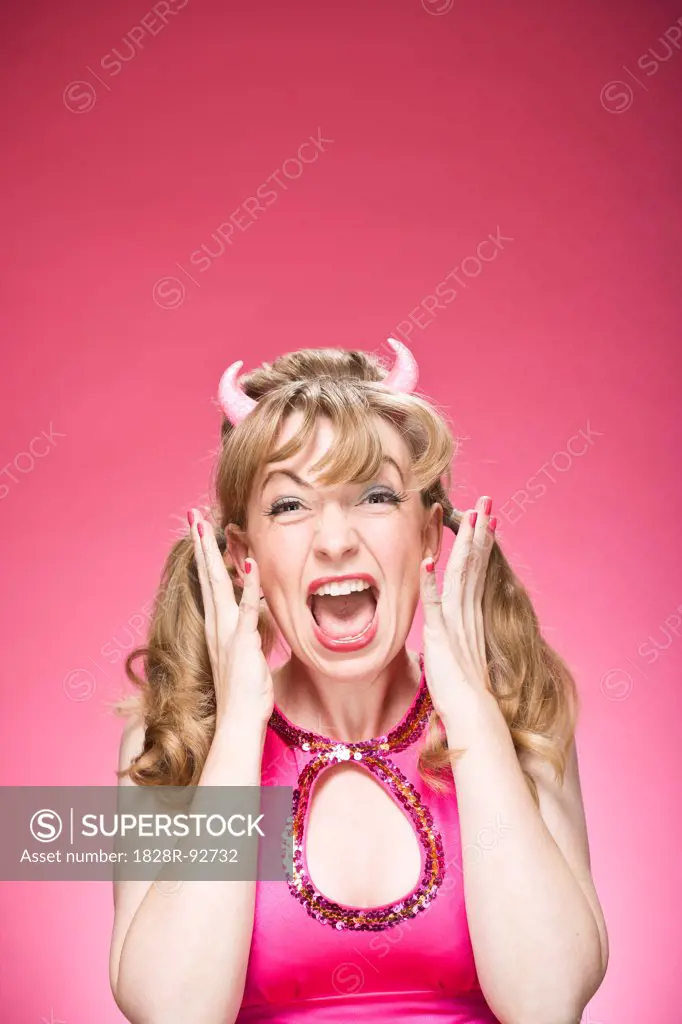 Portrait of Woman Wearing Devil Horns and Screaming