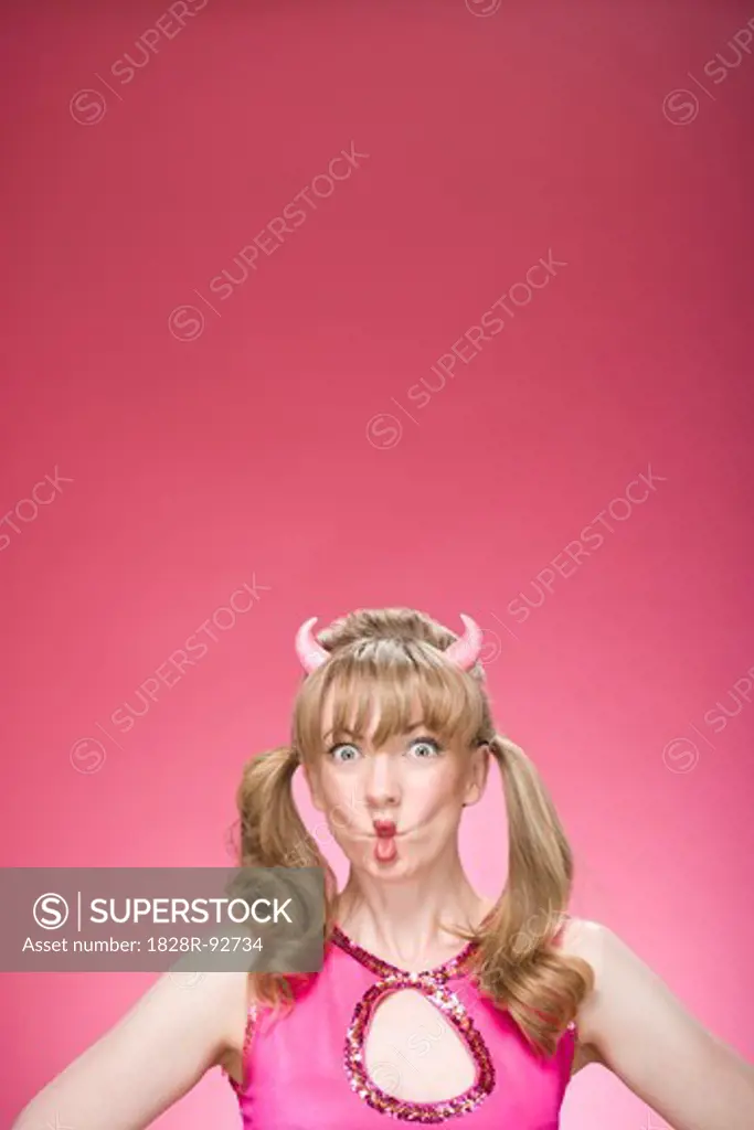 Portrait of Woman Wearing Devil Horns and Making Faces
