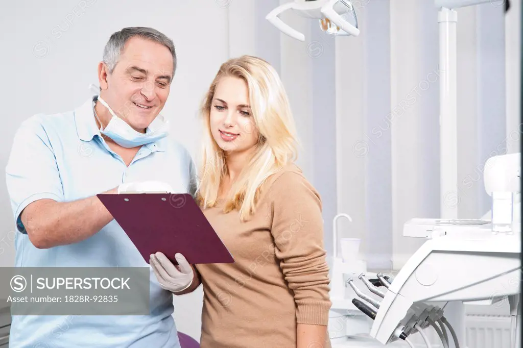 Dentist Explaining Medical Chart to Patient in Dentist's Office, Germany