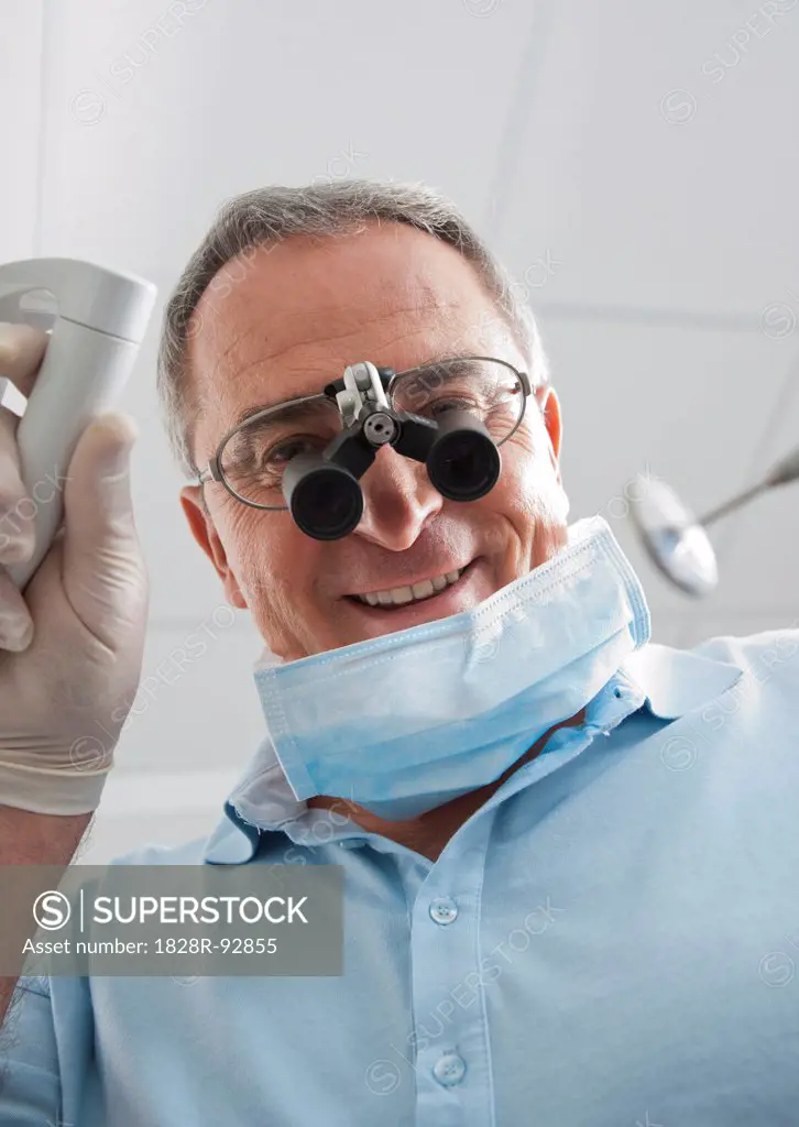 Close-up of Dentist with Magnifier on Eyeglasses in Dental Office, Germany